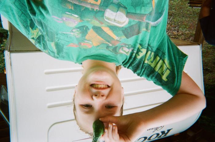Girl in t-shirt holding vegetable