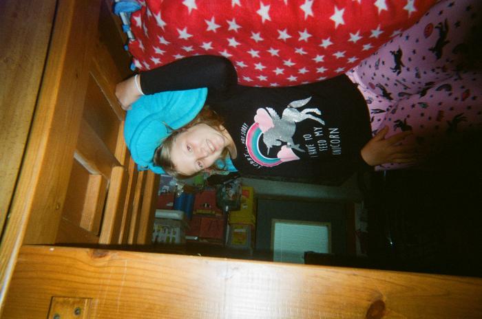 Girl in pajamas on bunk bed