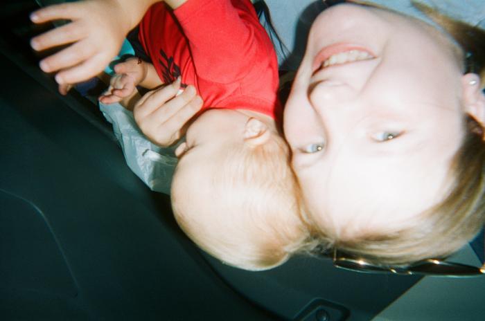 Smiling girl holding toddler