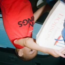 Toddler holding a large book 