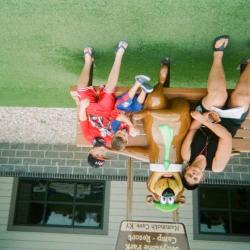 Woman and two boys on bench with Yogi Bear statue, Mammoth Cave State Park