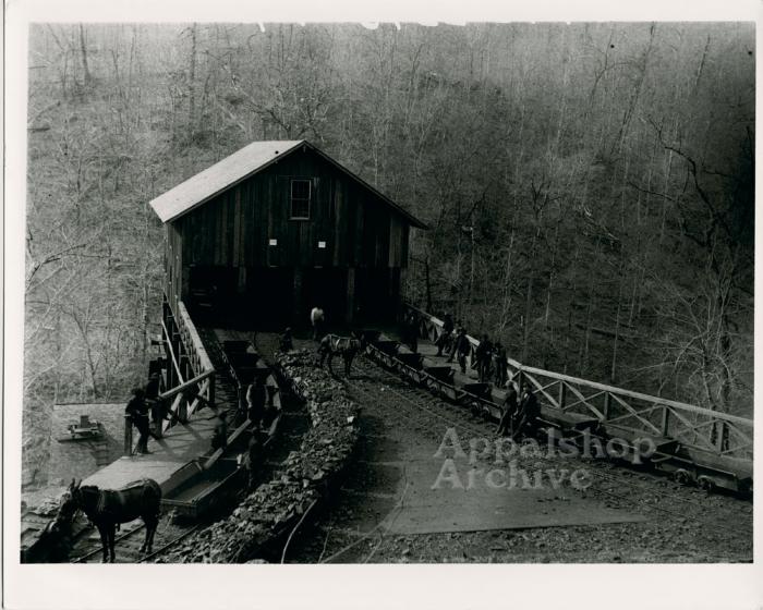 Wooden coal tipple with cars
