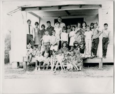Production still of posed group of children and adults, exterior - The Struggle of Coon Branch Mountain
