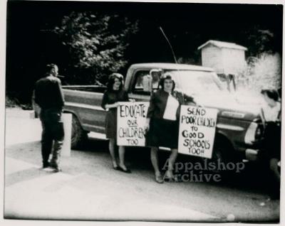 Production still of people with protest signs - The Struggle of Coon Branch Mountain