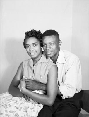 Interior portrait of embracing couple