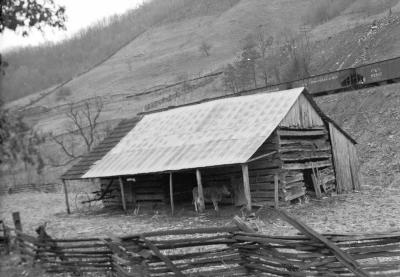 Barn with Chesapeake and Ohio railcars in background