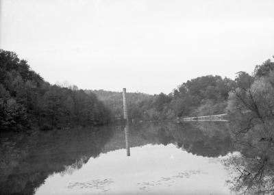 Smokestack at the edge of a pond