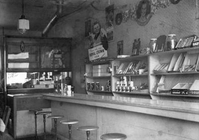 Lunch counter with candy bars, cigarettes, and canned food