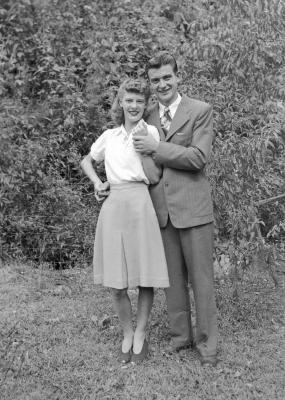 Exterior portrait of a couple holding hands