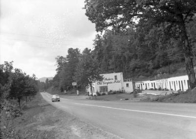 Exterior view of the Old Virginia Motel with car driving past