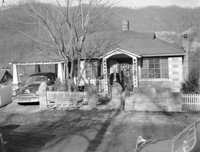 Couple standing in entryway of brick home