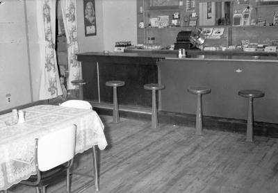 Interior of lunch counter with squatting child