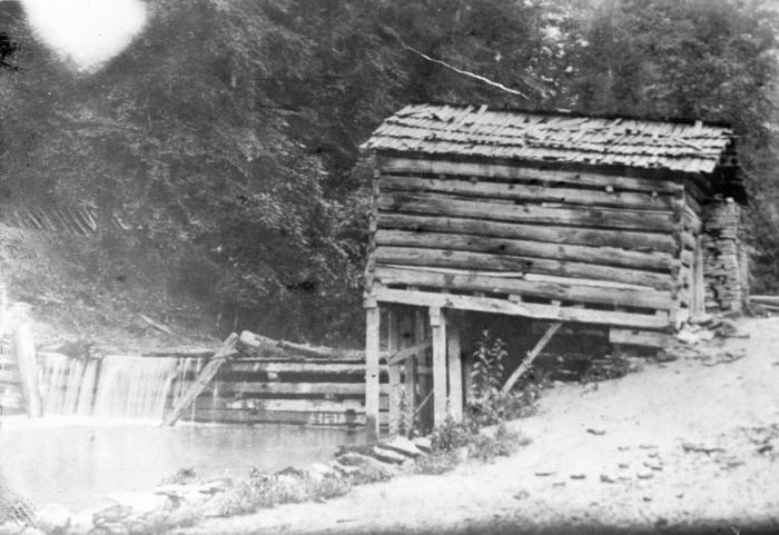 Notched-wood cabin on stilts near waterway