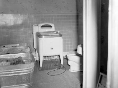 Buckets of laundry and washing machine