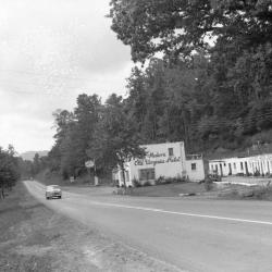 Exterior view of the Old Virginia Motel with car driving past