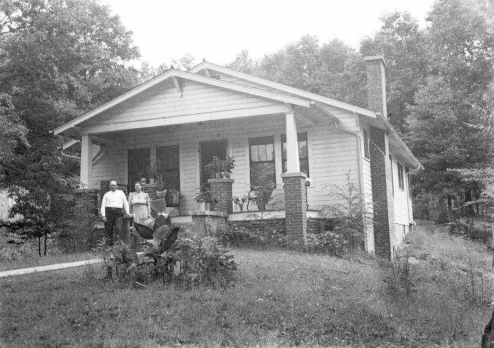 Mr. and Mrs. Taulbee Vanover pose in front of their home