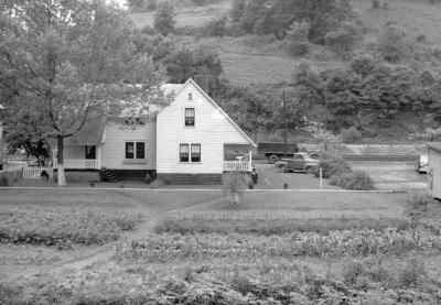 Exterior of two story home with garden