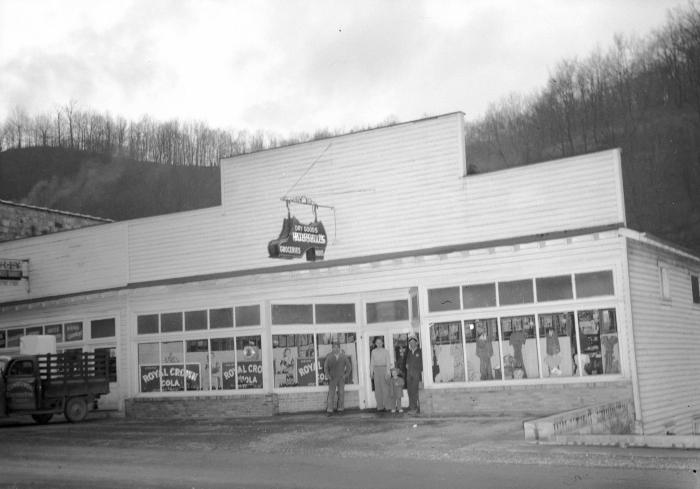 Group posing outside of Bussell's Grocery and Dry Goods Store