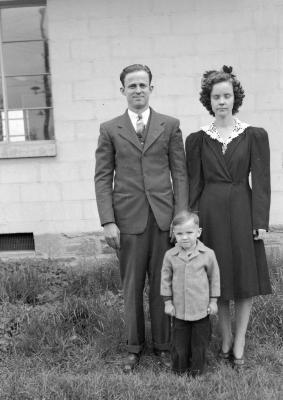 Exterior portrait of man, child, and woman with eyes closed