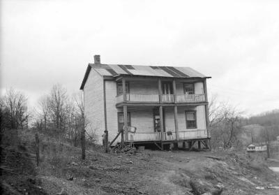 Two story building with porch and balcony
