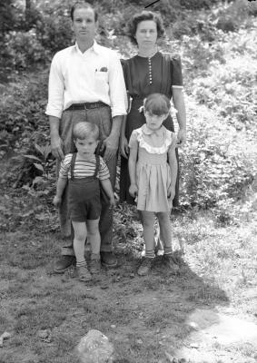 Family portrait of four with children in striped socks