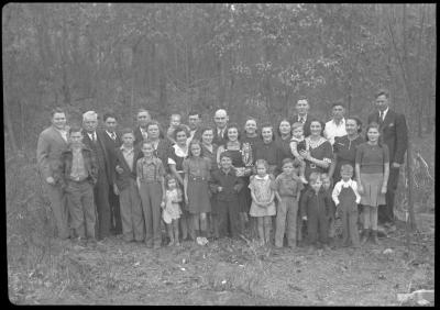 Group portrait of large family in front of treeline
