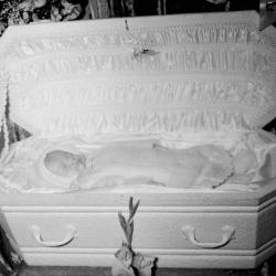 Deceased baby in casket, centered