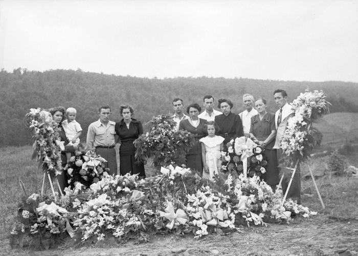 Group portrait at adorned gravesite