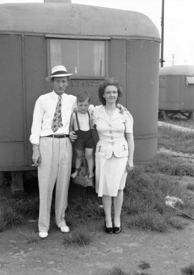 Family portrait with toddler standing on trailer coupling
