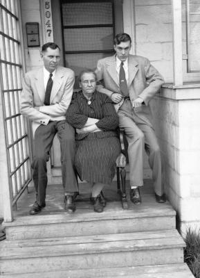 Family seated on wooden chair
