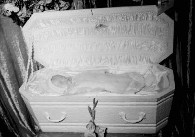 Deceased baby in casket, centered