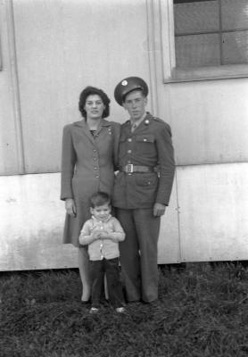 Exterior portrait of woman, man in military uniform, and child