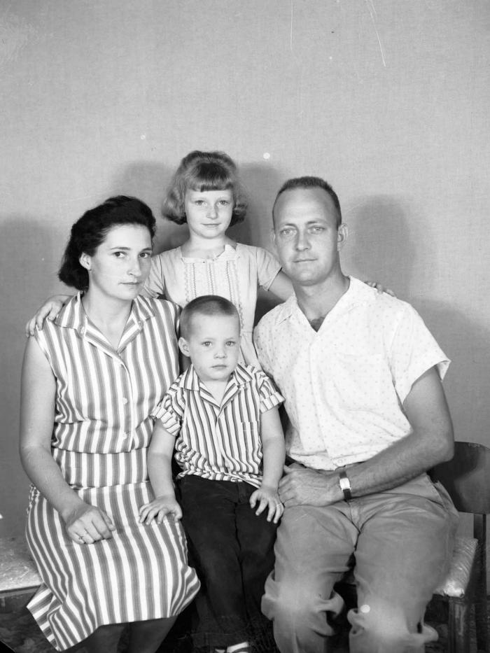 Interior portrait of family wearing patterned clothing