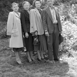 Group portrait, man holding eyeglasses
