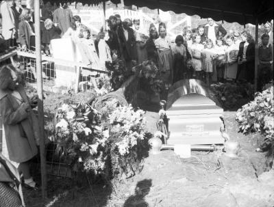 Group of young girls gathered around graveside tent