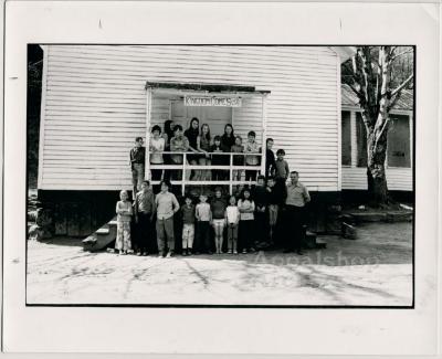 Production still of children in front of school building - Kingdom Come School
