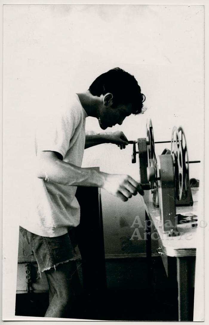 Man [Herb E. Smith] working at film rewinds