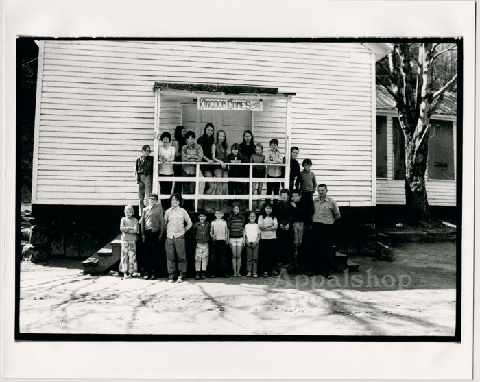  Production still of children in front of school - Kingdom Come School
