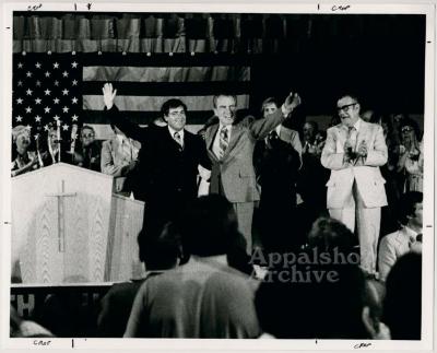 Richard Nixon and C. Allen Mucie on stage waving to crowd