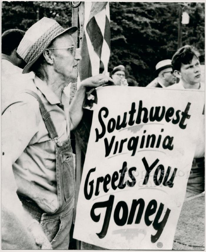 Production still of man holding sign at UMWA rally - UMWA 1970:  A House Divided