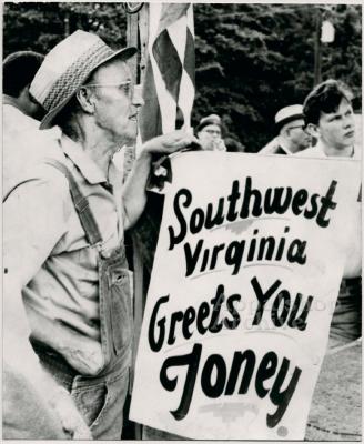 Production still of man holding sign at UMWA rally - UMWA 1970:  A House Divided