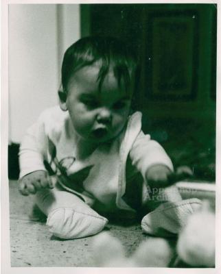 Baby reaches for toy